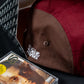 "imagine that" 5ive Panel Hat, packaging box and cassette, black background.