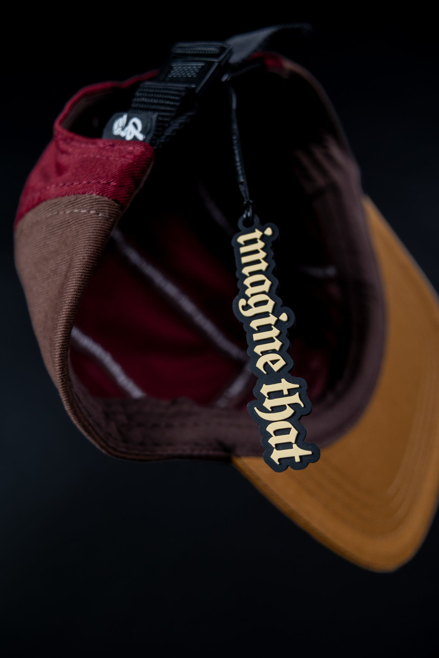 Hanging "imagine that" 5ive Panel Hat with hangtag, and black background.