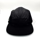 Black Nylon Lacoste 5 Panel, green alligator logo on the side panel, with white background.