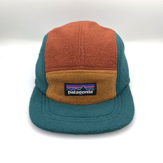 Brown, tan and cyan Patagonia fleece 5 Panel Hat upcycled, iconic logo on the front, with a white background.