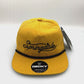 Spinning mustard yellow Springdale Utah 5 Panel Hat, rope on the front, with a white background.