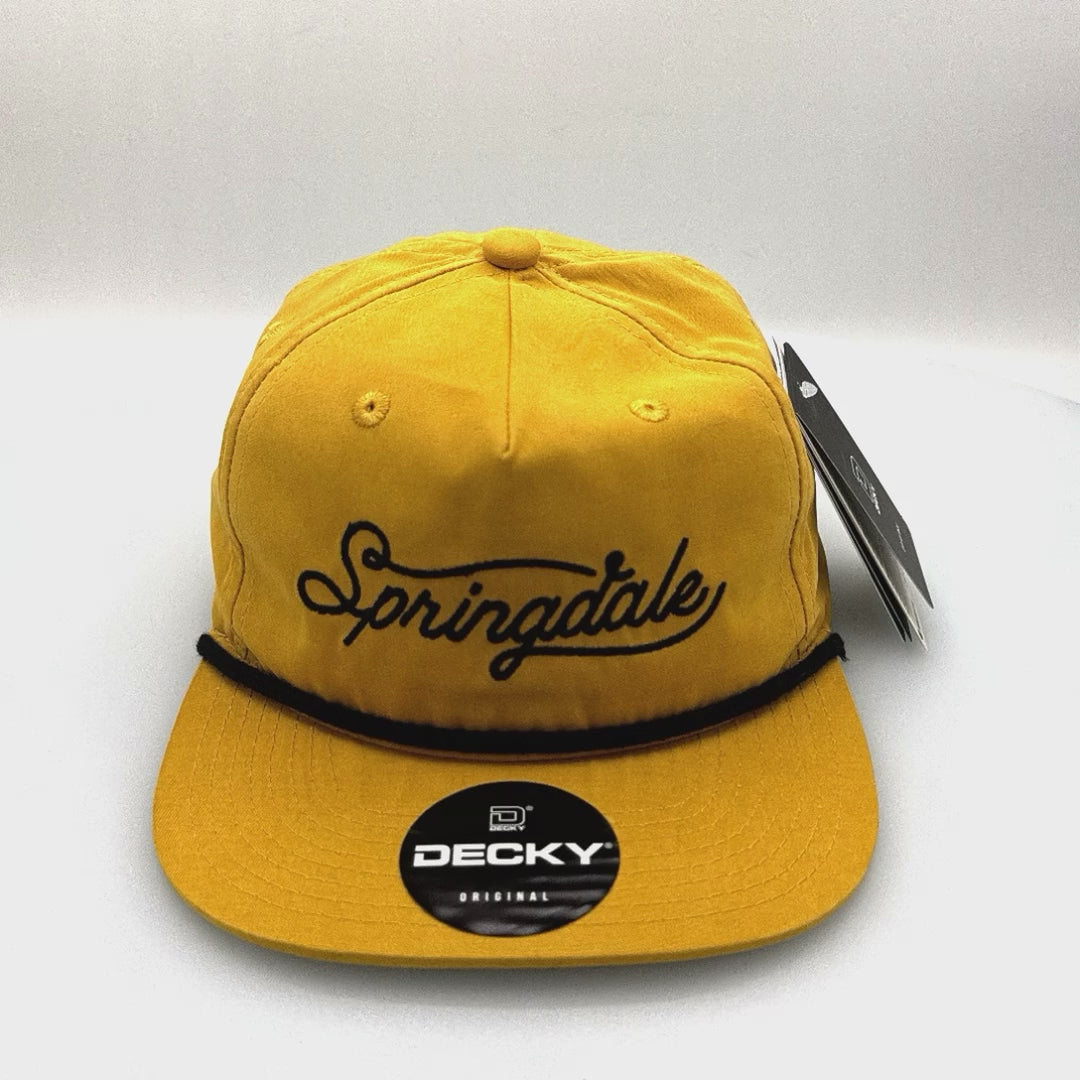 Spinning mustard yellow Springdale Utah 5 Panel Hat, rope on the front, with a white background.