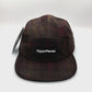 Spinning brown plaid pattern Paper Planes 5 Panel Hat, with a white background.