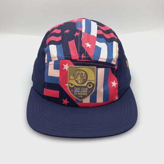 Spinning navy, pink, blue and white La Habana Cuba Puma 5 Panel Hat, with a white background.