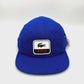Spinning Blue Netflix Lacoste 5 Panel Hat, white alligator along with Netflix logo on the front, with white background.
