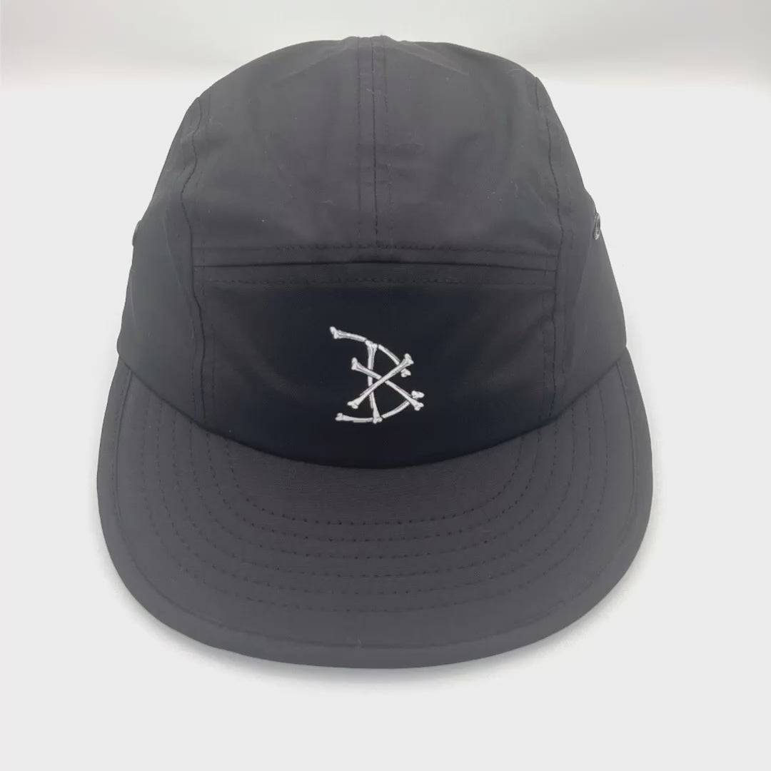 Spinning Black BAIT 5 Panel Hat with white bones logo on front panel, white background.