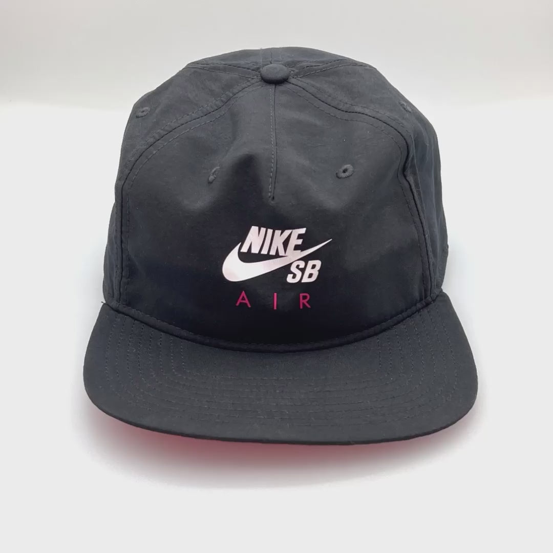 Spinning Nike Air SB Black 5 Panel Hat, Nike Air SB logo on front, with white background.